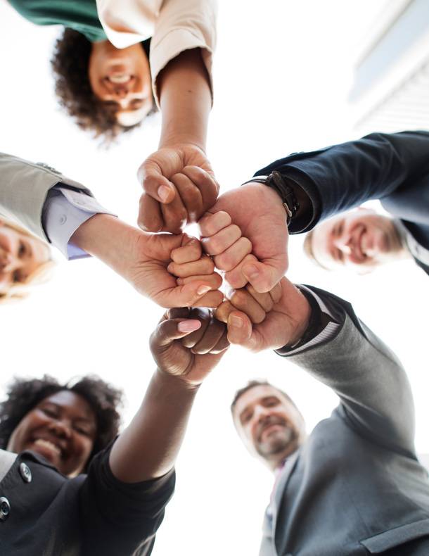 a group of people holding their hands together