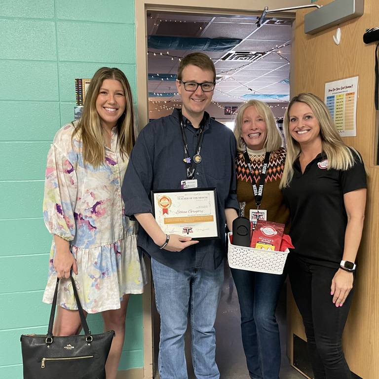 a group of people standing in a hallway