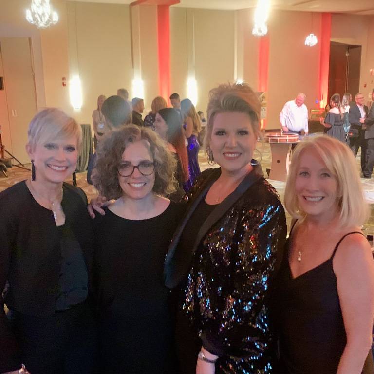 a group of women posing for a photo