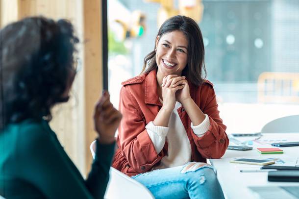 a woman smiling at another woman