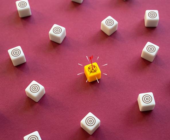 a yellow and white cubes with a dart in the center