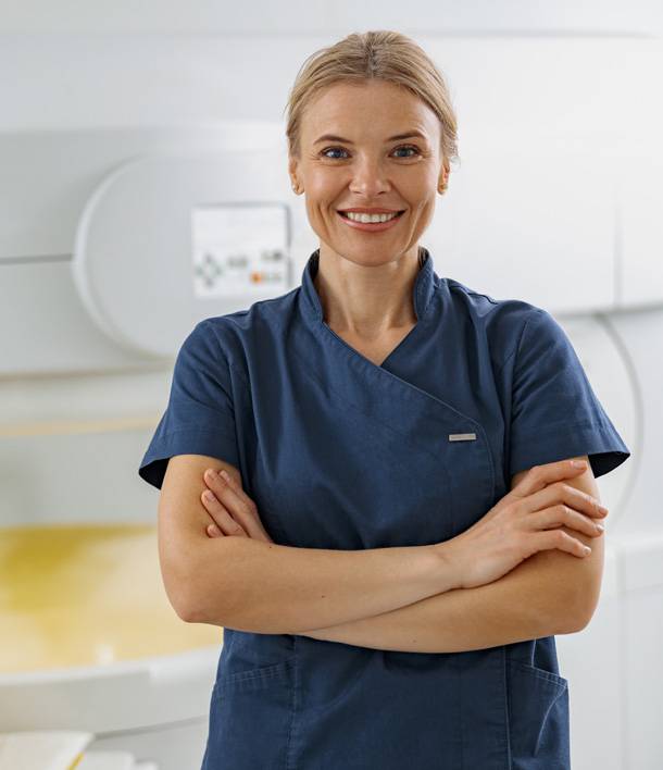 a woman in blue scrubs smiling